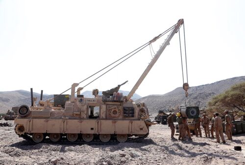 a-group-of-men-working-on-an-armored-track